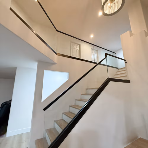 6850ec69611898bb24dfd5db_Glass stair railing with black accent